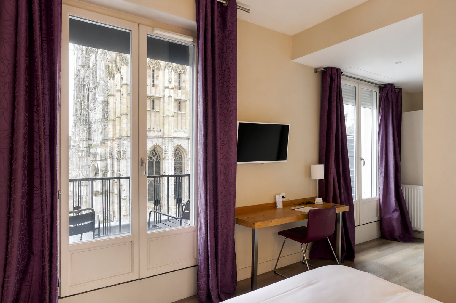 Chambre supérieure de l’Hôtel Cardinal Rouen avec lit double, bureau et vue sur la cathédrale